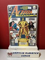 Image of Action Comics #600 Golden Anniversary issue comic book showing gold superhero statue on cover and various story highlight boxes.