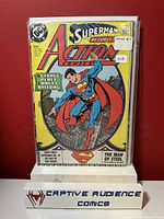 Photo of comic book Action Comics #643 featuring Superman on the cover, stored in protective sleeve with label showing the issue number and price.