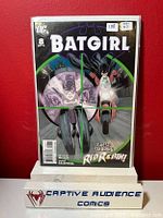 Front cover of Batgirl #8 comic book showing Batgirl and Red Robin, sealed in protective sleeve with label showing grade NM- 7.