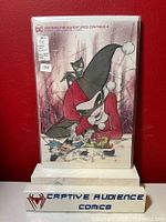 Front cover photo of Batman: The Adventures Continue #4 comic, featuring Peach Momoko cover with Harley Quinn, Catwoman and Poison Ivy. Comic is sealed in protective comic bag with backing board and has one white sticker showing grade NM+ and $25 price.
