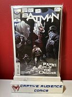 Front cover photo of Batman #92 comic book featuring the issue's title 'Pawns of the Designer' and artwork depicting Batman, Joker, and other characters in dark tones.