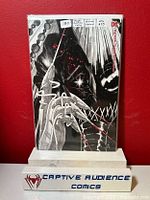 Photo of Batman comic book with Megan Hutchison Cates minimal variant cover in protective sleeve against red background, with Captive Audience Comics label.