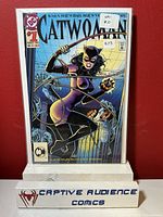 Front cover of Catwoman #1 comic book showing Catwoman in purple costume, whip in hand, with Gotham cityscape background.