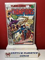 Front cover photo of The Champions comic book issue #14 showing the complete comic book in a protective plastic sleeve with a red background.