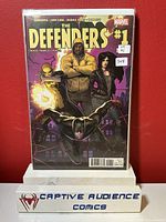 Front cover photo of The Defenders #1 comic book showing main characters and condition, with price sticker and display stand from Captive Audience Comics.
