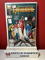 Photo of Excalibur #1 comic book in plastic sleeve with graded VF+ sticker, featuring the Marvel superhero team on cover.