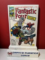 Comic book Fantastic Four #348 displayed against red background on clear easel, showing front cover.