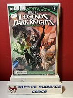 Front cover of Legends of the Dark Knights #1 comic book showing first Robin King appearance, in plastic protective sleeve, placed on branded Captive Audience Comics stand.