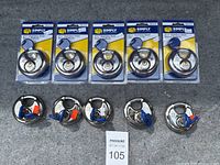 Ten new stainless steel disc padlocks from Simply brand in original packaging, each with two keys on blue key heads wired onto rings, displayed laid out on gray surface.