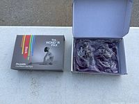 Box and open box showing back gel pack in dark violet gel sealed in plastic, labeled The Wonder Pax.