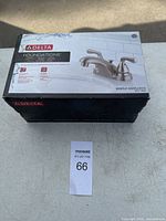 Box of new Delta Foundations brushed nickel bathroom faucet.