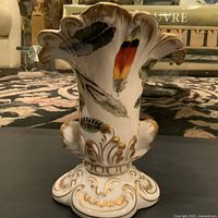 Front view of the Chelsea House vase showing the feather designs and gold detailing at the base and rim.