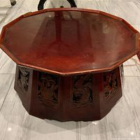 Front view of the extra-large vintage Asian wood carved stand showing the octagonal top and intricate openwork carved panels on the base.