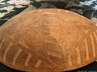 Top down close-up view showing detailed carved patterns on the shell-shaped bowl surface.