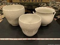 Photo overview of all three white porcelain KAISER planters with scale showing approx. 12-14 inch width.