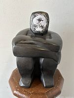 Front view of the ceramic modernist sculpture showing the crossed arms and inverted face mask detail.