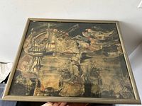 Front view of framed artwork showing abstract collage with mixed textures and colors, signed by Georges Csató.