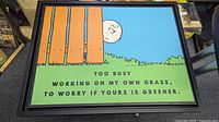 Framed vintage Peanuts Linus print with motivational motto.
