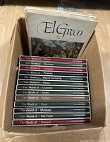 Photo of 13 Time-Life 'The World of' series art books stacked in a box, with the large 'El Greco' book at the back.