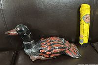 Hand-carved and painted wooden Loon figurine, showing side profile and detailed paintwork on feathers and head.