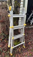 Multi-use aluminum ladder folded and standing upright