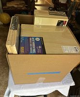 Box of cradled wooden artist panels in sealed packaging showing multiple sizes