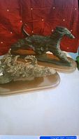 Pair of Afghan hound sculptures showing their pose and bases