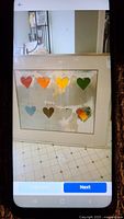 Photo of framed lithograph print with eight colorful hearts in two rows on white background.