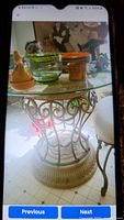 Full view of the bistro table with glass top displaying some decorative items on top, showing heavy base and part of chair