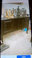Solid black wooden buffet table with two cabinets and three drawers, shown with decorative items on top for size reference but not included.