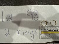 Overview of two rings on handwritten note with ruler