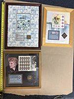 Three framed limited edition stamp sets - Lucille Ball, Arctic Animals with polar bears, and Pan-American Exposition Buffalo - arranged on floor with measuring tape for size reference.