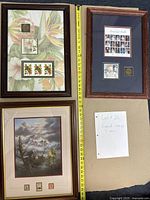 Overview photo showing all three framed stamp lots including a note identifying the lot as 'Framed Stamps'