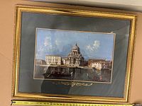 Frontal view of the framed artwork showing the historic building scene, details of the image and frame with measuring tape along bottom for scale.