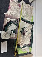 Top view of multiple crystal cups placed on cloths with measuring tape indicating size.