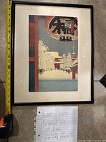 Full view of the framed Asian art print with measuring tape showing width around 18 inches.