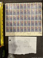 Sheet of unused 50th anniversary Solo Transatlantic Flight 13 cent stamps with measuring tape for scale and handwritten lot note.