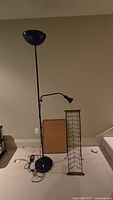 Front view of the floor lamp, CD holder, and cork board displayed side by side
