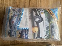 Yellow air jack bag in original packaging showing vehicle lifting instructions and photos on the label.