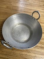 Top view of the heavy metal wok showing the interior surface with signs of use.