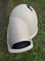 Front view of the Indigo dog kennel showing the entrance opening and the Indigo brand logo on the dome shape.