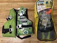 Two life jackets and a zipped pouch containing snorkeling gear