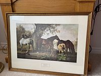 Framed print showing four horses including mares and foals in a natural setting under a tree.