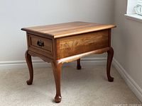 Front three-quarter view showing drawer and cabriole legs