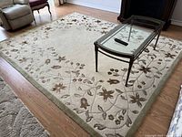 Top-down view of full rug laid out in living room with coffee table visible