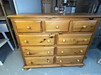 Full front view of pine dresser with nine drawers
