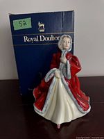 Front view of figurine with original box in background