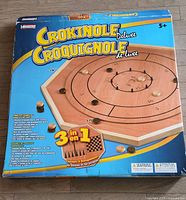 Box of Crokinole Deluxe 3-in-1 game showing product branding and game type.