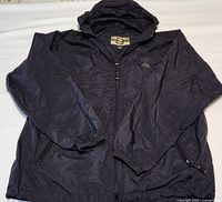 Front view of men's black North End Ezepack jacket laid flat showing hood, front zipper, and elastic cuffs.