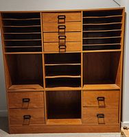 Full frontal view of the Sauder craft storage unit showing multiple shelves, central drawers, and compartments.